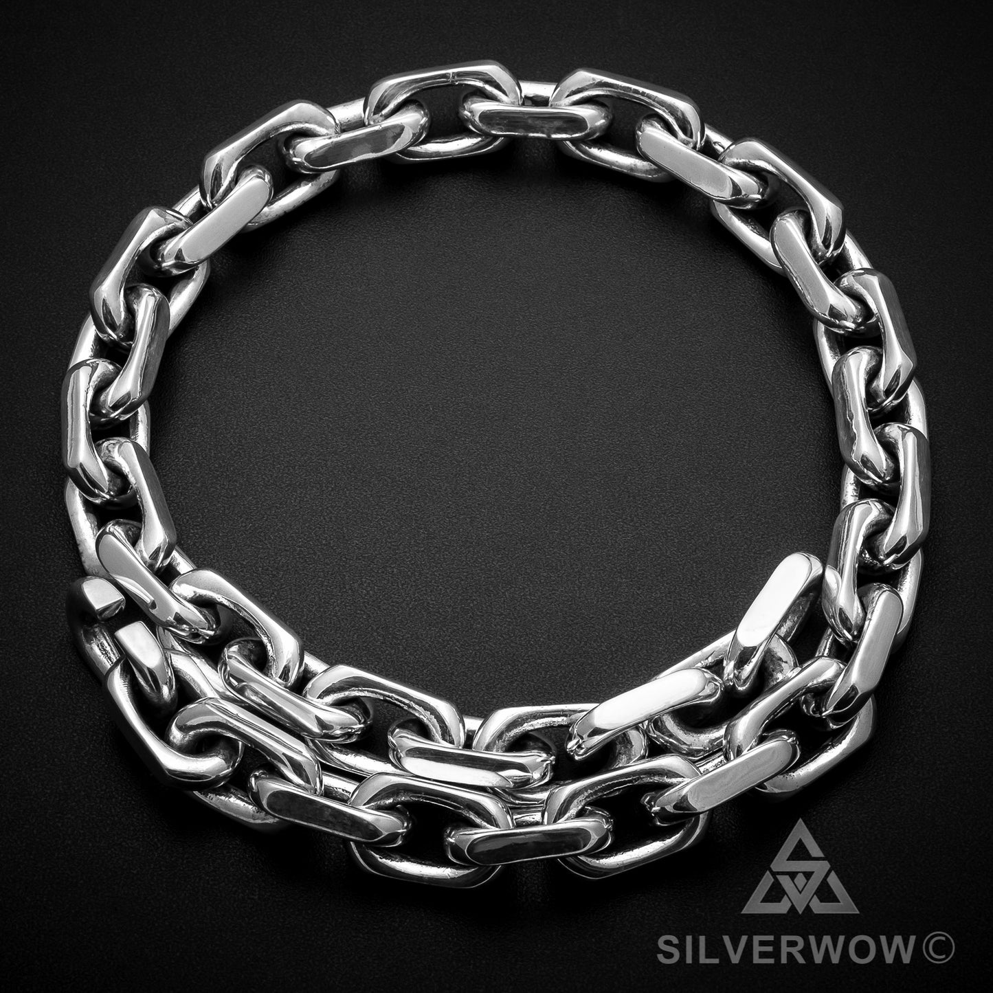 15mm sterling silver chain necklace coiled in round shape on dark background