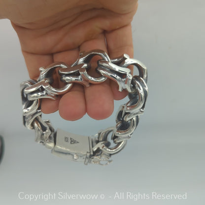 Closeup of heavy Bismarck-style bracelet in polished silver