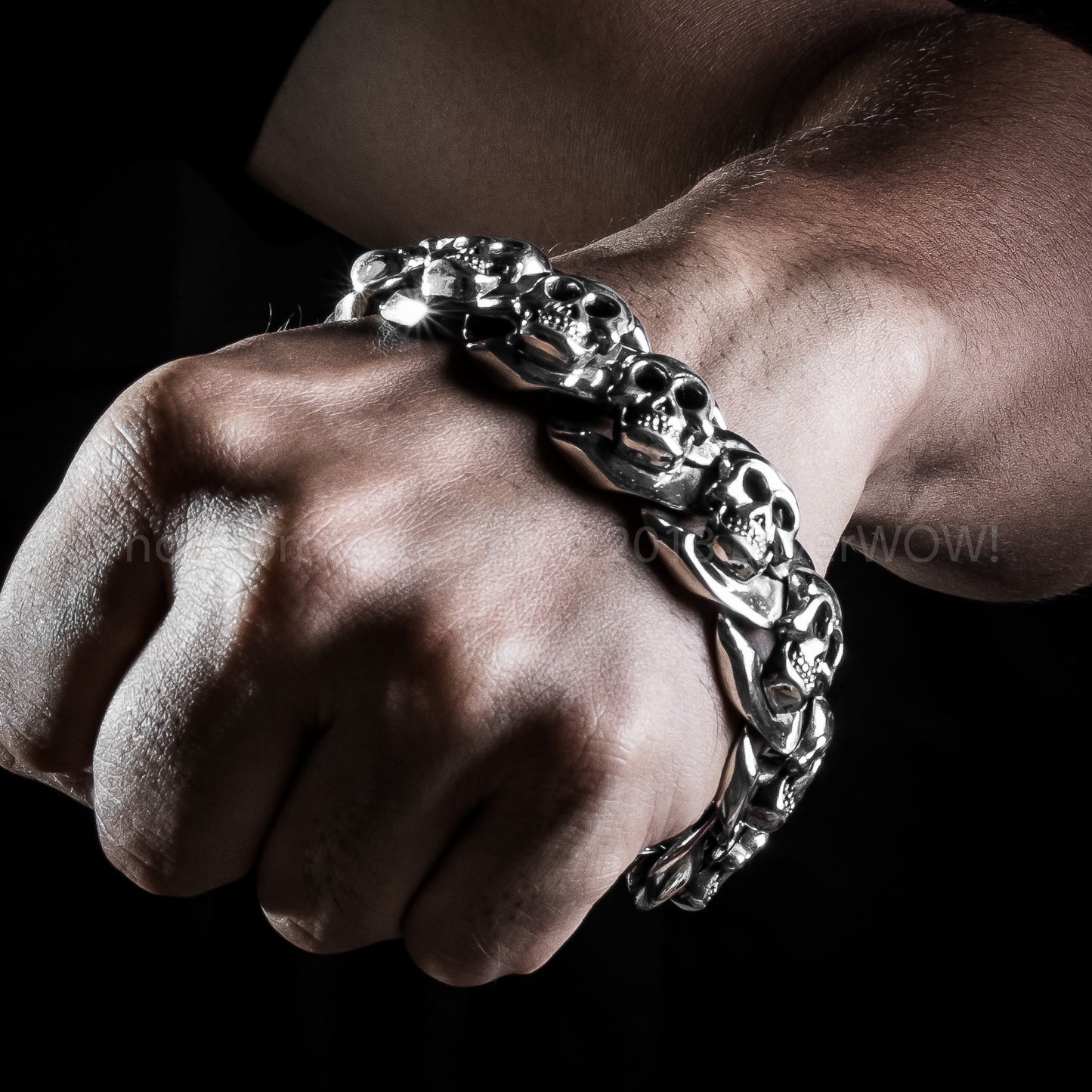 Thick silver skull bracelet on wrist – 925 sterling, 23mm wide
