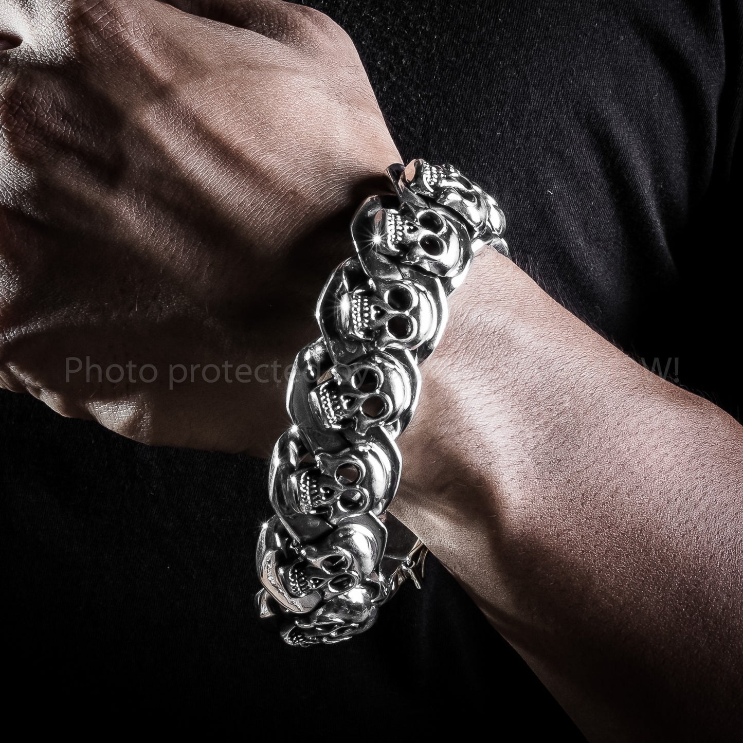 Wrist close-up of men’s sterling skull bracelet – solid 23mm size
