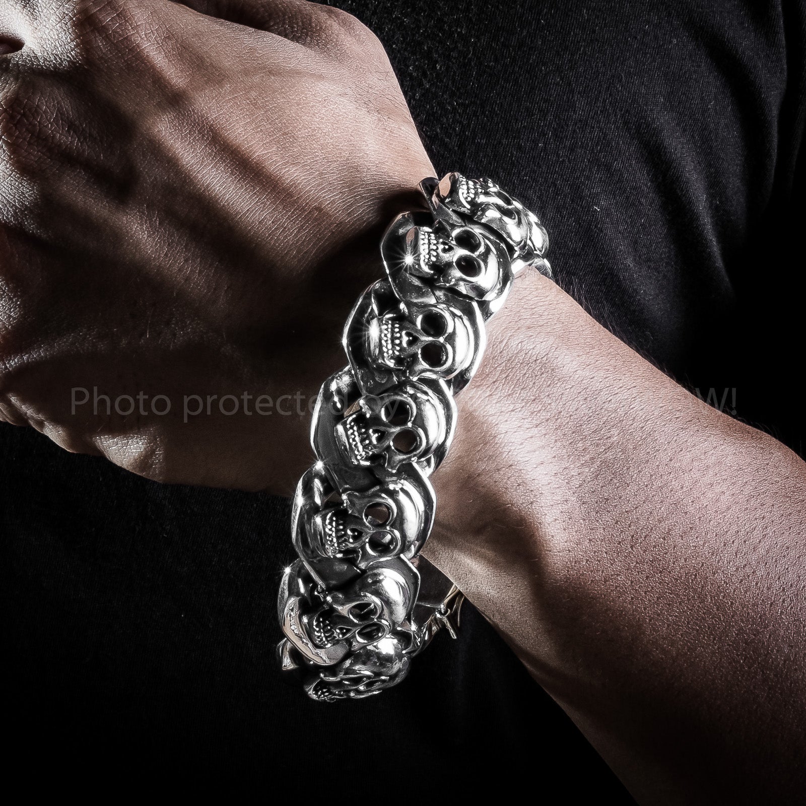 Wrist close-up of men’s sterling skull bracelet – solid 23mm size
