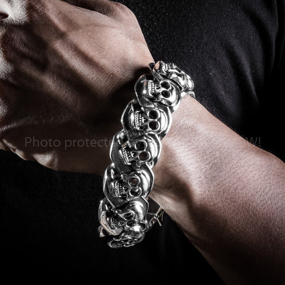 Wrist close-up of men’s sterling skull bracelet – solid 23mm size
